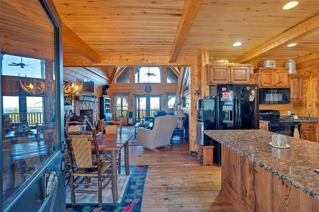 a view of a patio with dining table and chairs under an umbrella