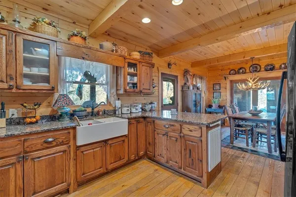 a kitchen with sink cabinets and wooden floor