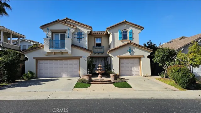a view of a white house with large windows and a small yard