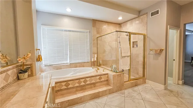 a spacious bathroom with a tub shower and sink