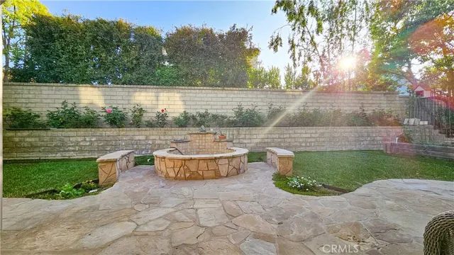 a backyard of a house with fountain and outdoor seating