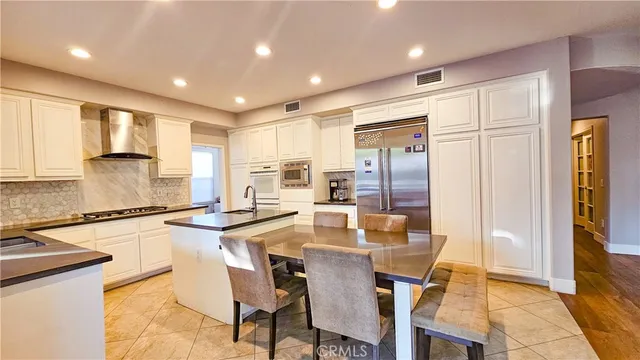 a kitchen with granite countertop sink cabinets and refrigerator