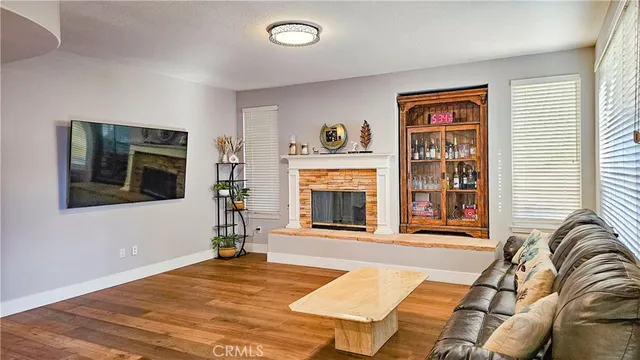 a living room with fireplace furniture and a window