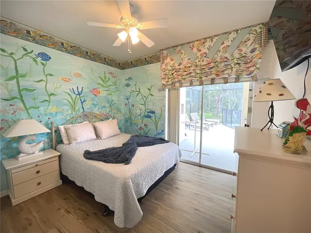 a bedroom with a bed and a painting on the wall