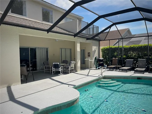 a view of a backyard with table and chairs under an umbrella