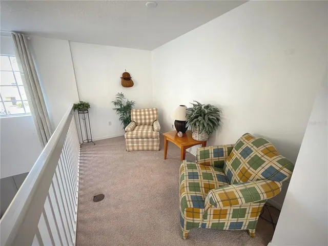 a bedroom with a bed a flat screen tv and a large window with the garden view