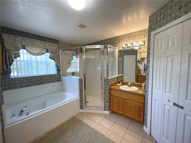 a bedroom with two beds and a window