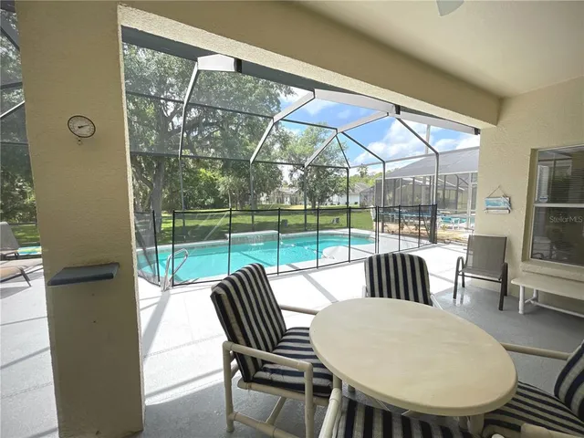 a view of house with backyard outdoor seating and hardwood
