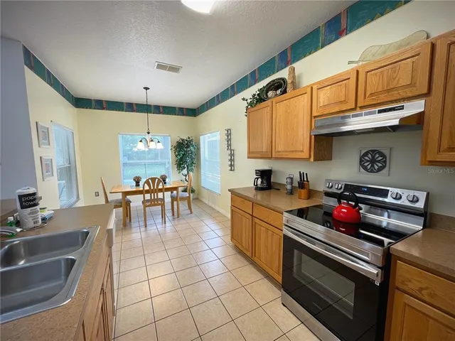 a kitchen with a table and chairs