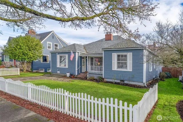 a front view of a house with a garden and yard