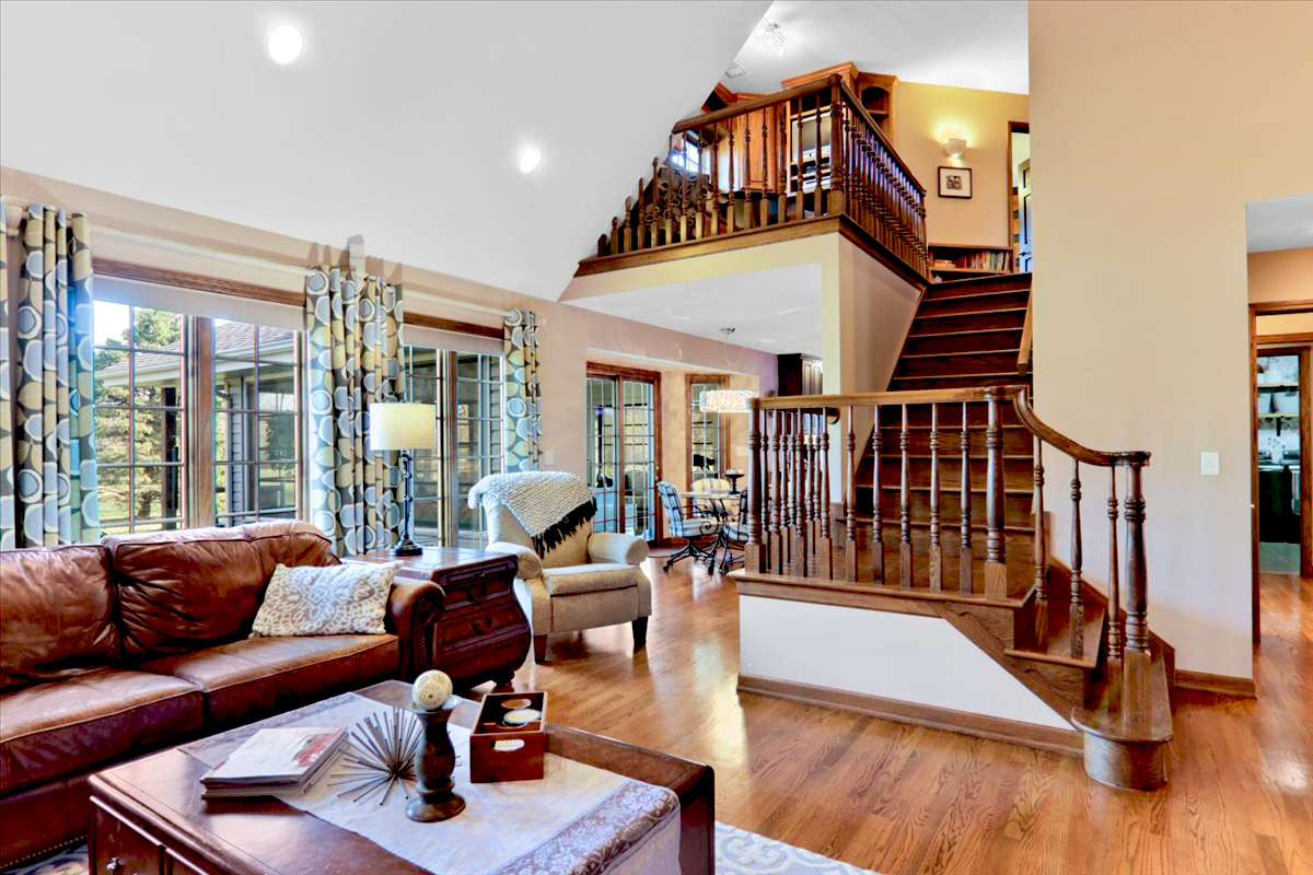 20379 Cedar Avenue Downs, IL 61736 - Photo 27 of 97 a living room with furniture stairs and a wooden floor