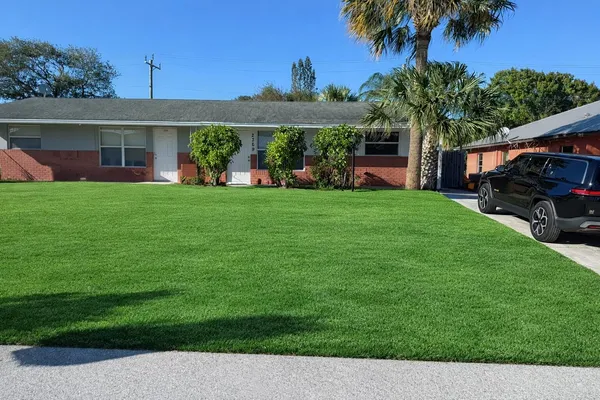 a front view of a house with a garden