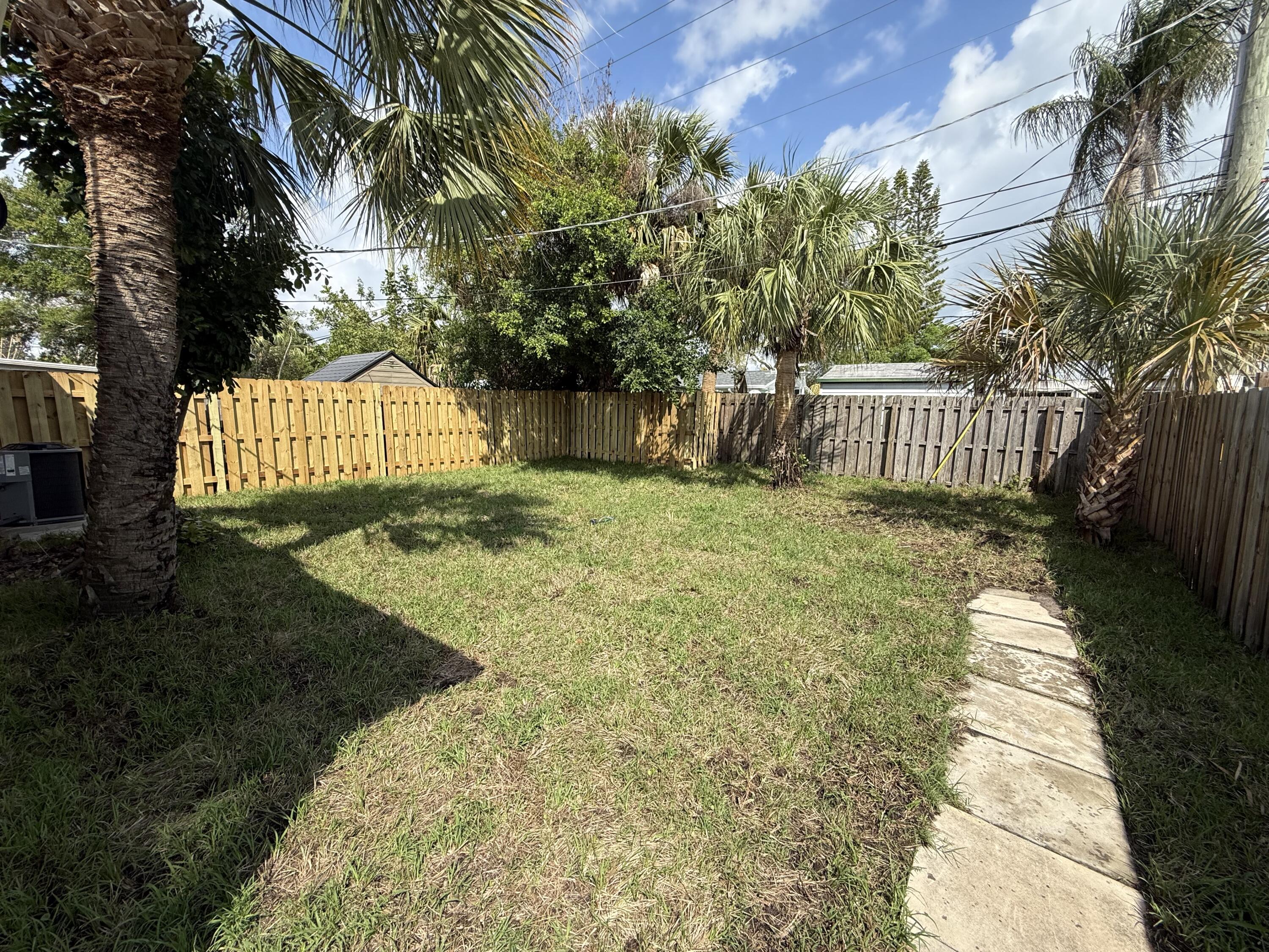 2369 Northeast Rustic Way Jensen Beach, FL 34957 - Photo 10 of 11 a view of backyard with green space