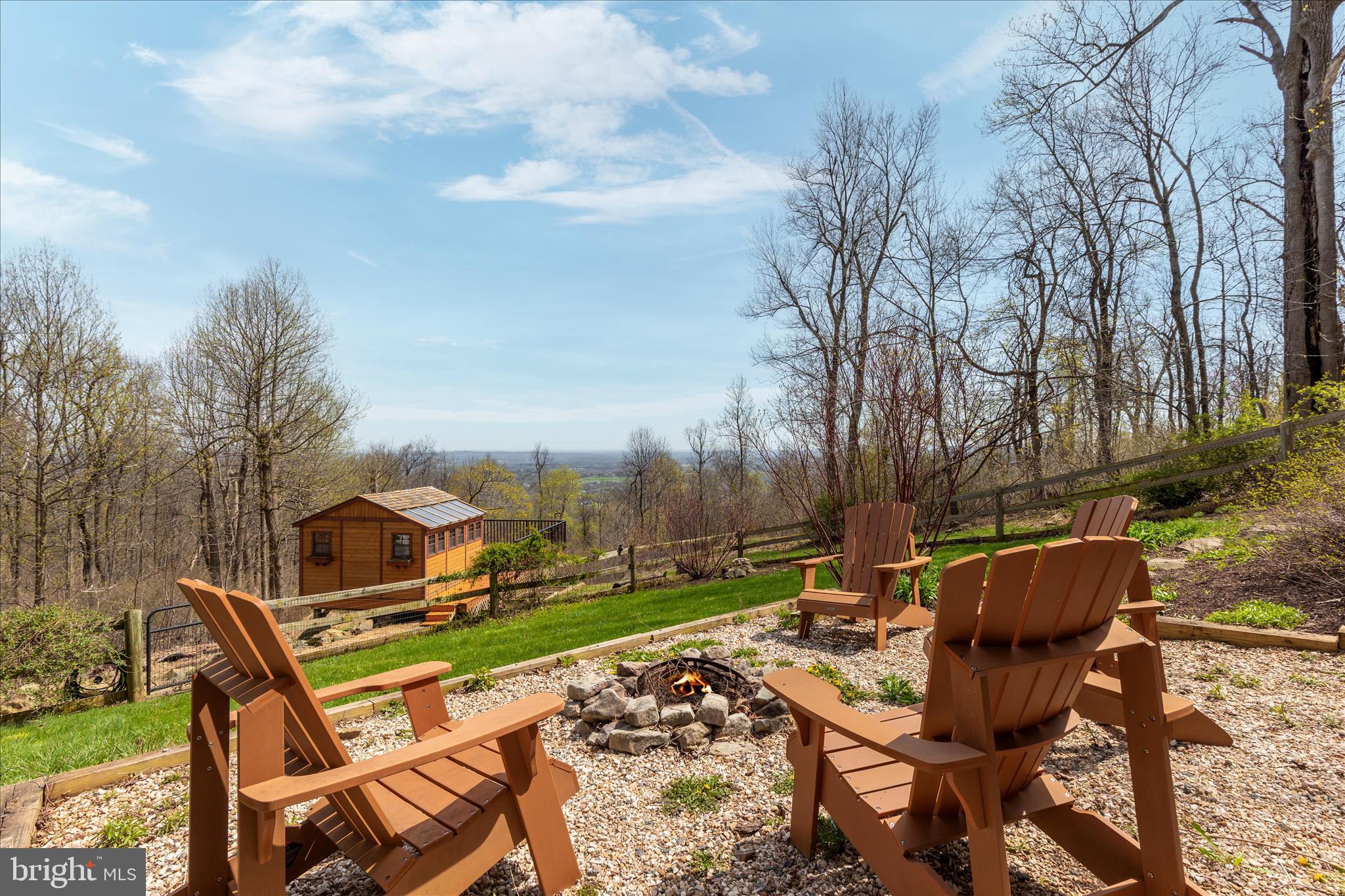 17352 Raven Rocks Road Round Hill, VA 20141 - Photo 7 of 47 a view of a patio with table and chairs with wooden fence
