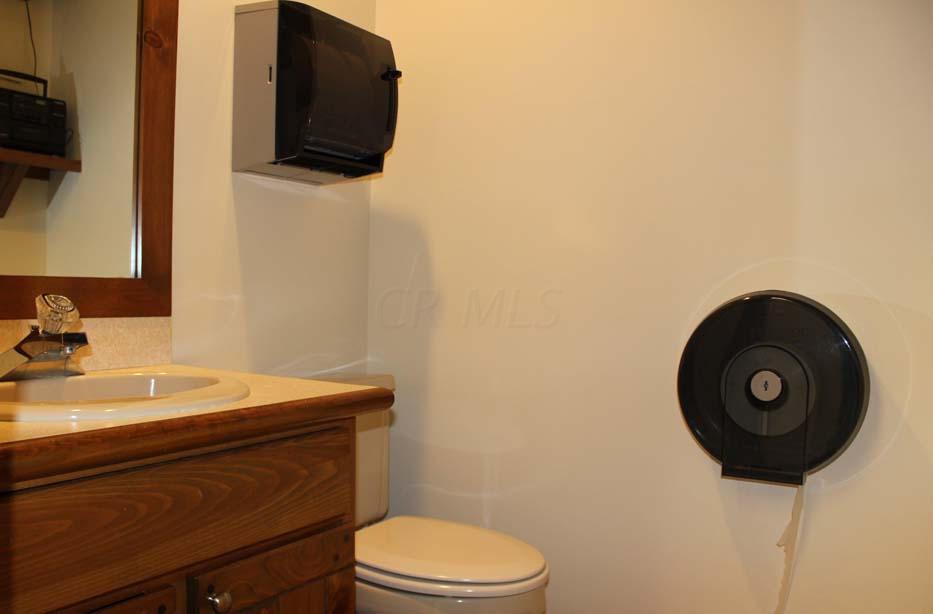 1900 Bethel Road Columbus, OH 43235 - Photo 11 of 24 Ceramic tile flooring. Ivory painted walls. Suspended ceiling. Recessed lighting. Ceiling exhaust. Enclosed vanity with single bowl sinktop. Linen/storage cabinet. Paper towel dispenser.