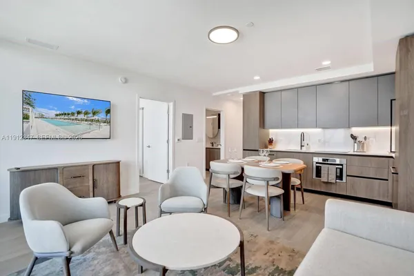 a living room with furniture a fireplace and kitchen view