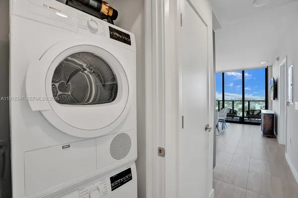 a view of a hallway with washer and dryer
