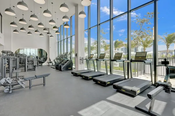 a room with gym equipment and large window