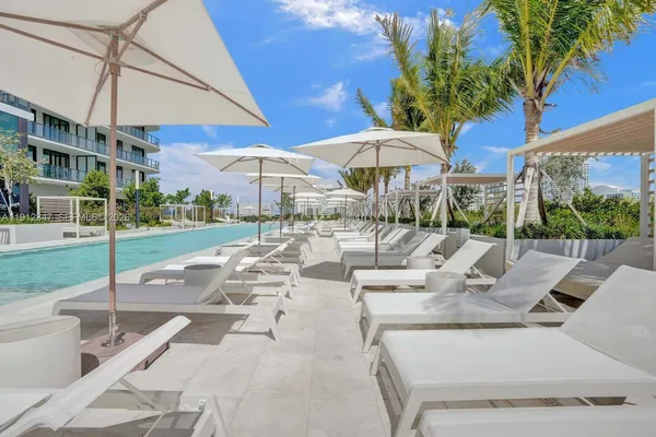 a view of a patio with a table and chairs under an umbrella
