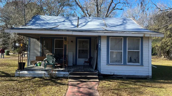 a view of a brick house with large windows