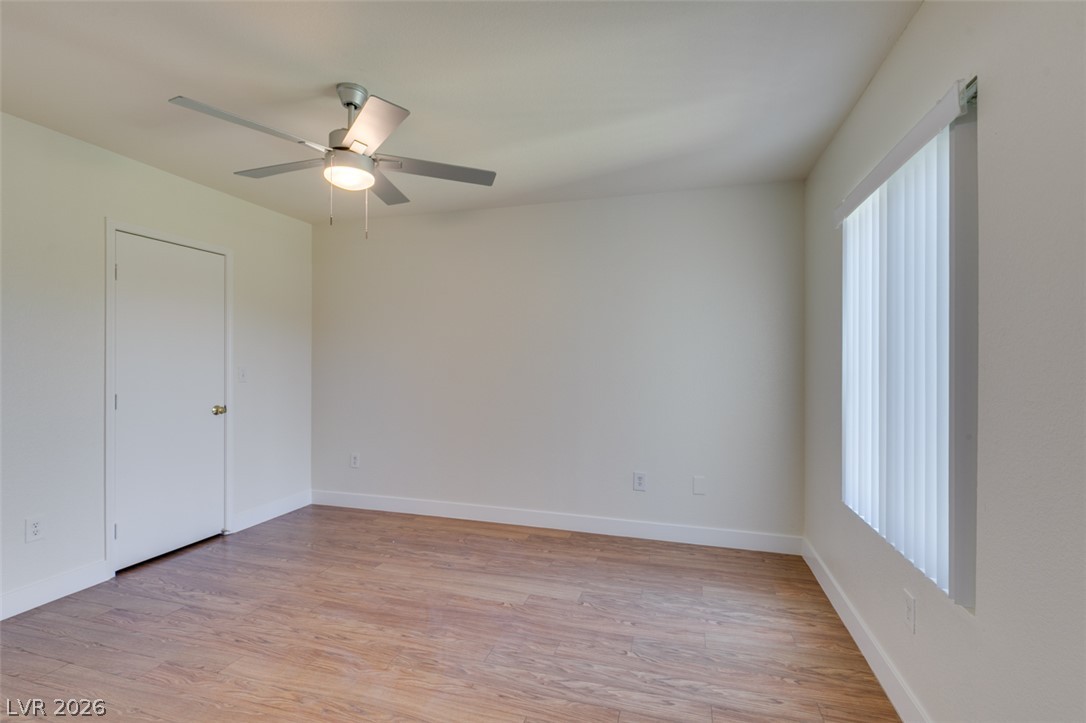 6650 West Warm Springs Road, Unit 2118 Las Vegas, NV 89118 - Photo 19 of 41 A well-lit bedroom features durable laminate flooring and a modern ceiling fan for comfort.