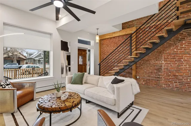 a view of a balcony with two plants and wooden fence