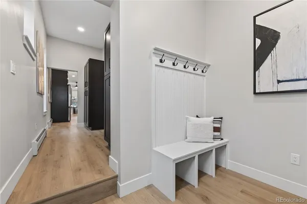 a bathroom with a granite countertop toilet a sink and a mirror