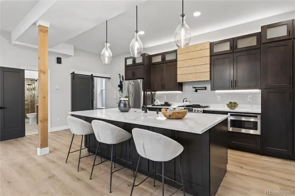 a kitchen with stainless steel appliances a sink stove and refrigerator