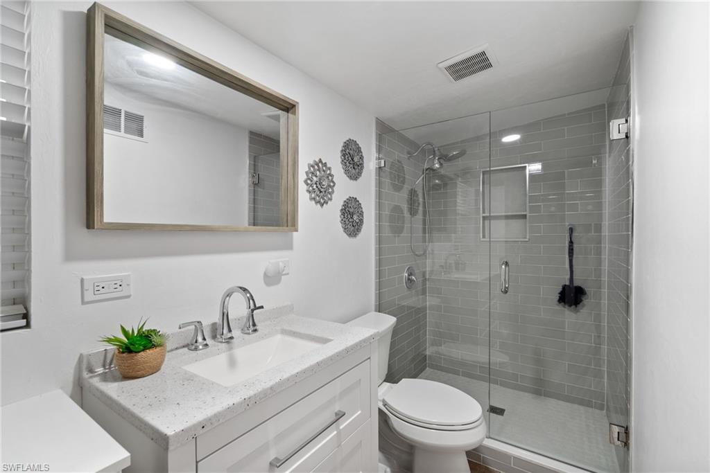 19034 Flamingo Road Fort Myers, FL 33967 - Photo 19 of 31 a bathroom with a sink toilet and shower