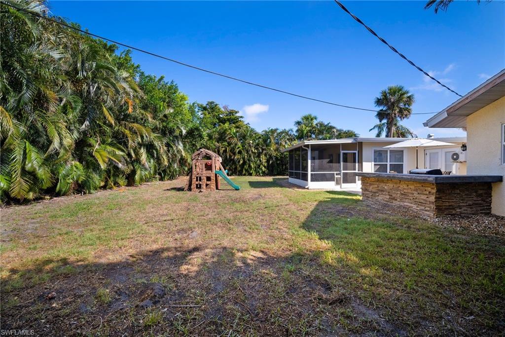 19034 Flamingo Road Fort Myers, FL 33967 - Photo 27 of 31 a view of a house with a yard