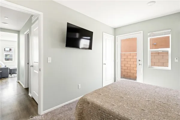 a bedroom with a bed and a television