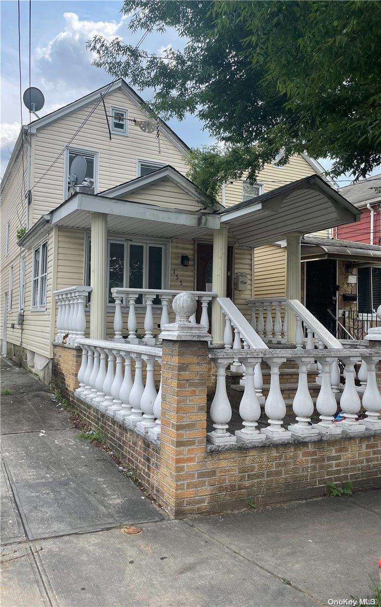 a view of a white house with a large windows