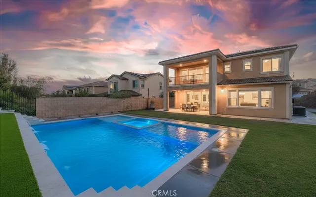 a swimming pool with outdoor seating and yard