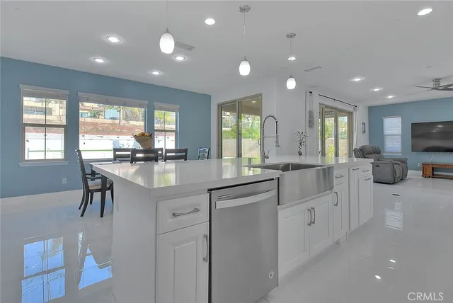 a kitchen with counter top space cabinets and appliances