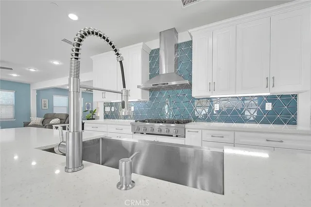 a kitchen with a table chairs and cabinets