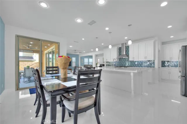 a dining room with kitchen island a table and chairs