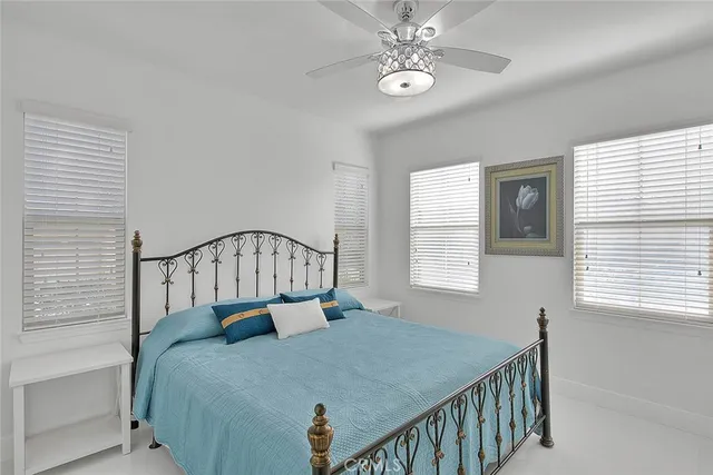 a bed sitting in a bedroom next to a window