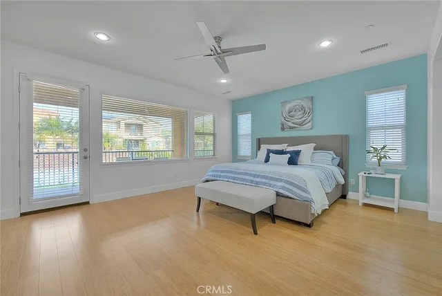 a bedroom with a large bed and a tv