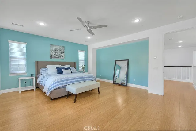 a bedroom with a bed and a painting on the wall