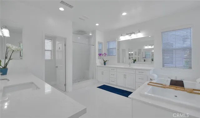a spacious bathroom with a sink a mirror and a shower