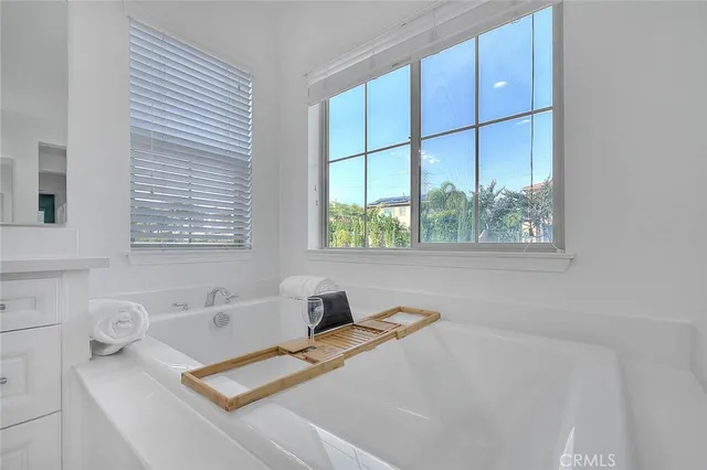a bath tub sitting next to a window
