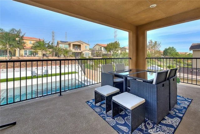 a balcony with furniture and wooden floor