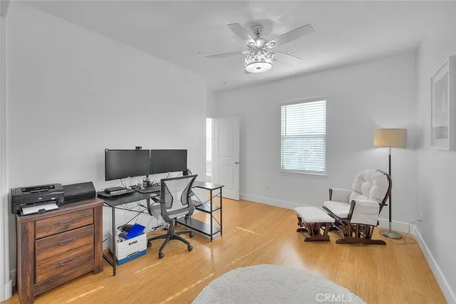 a view of a workspace with furniture and a window