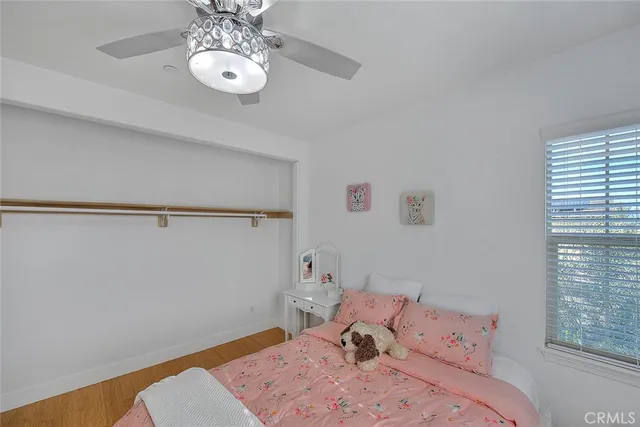 a bedroom with a bed and chandelier