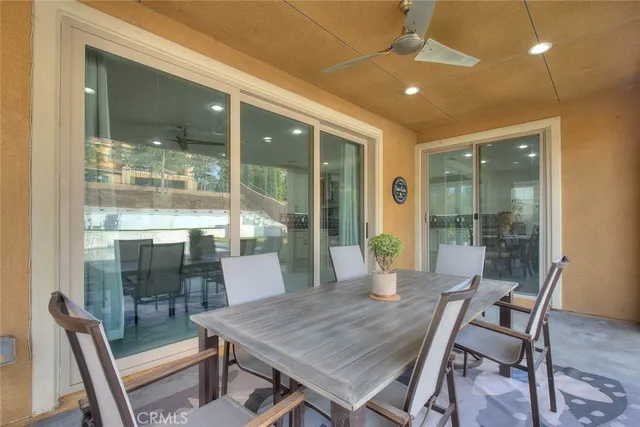 a view of a porch with chairs and backyard