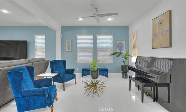 a living room with furniture and a potted plant