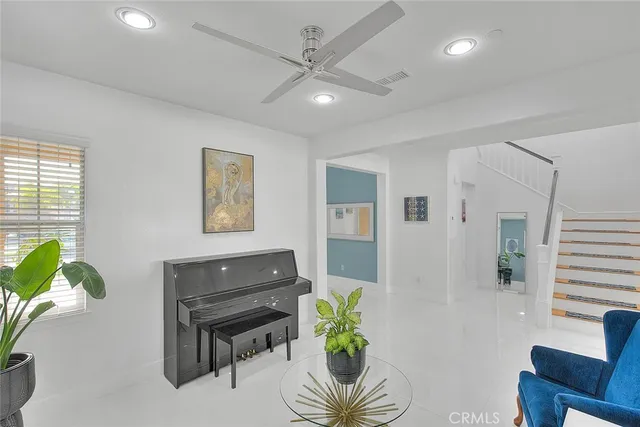 a living room with furniture and a potted plant