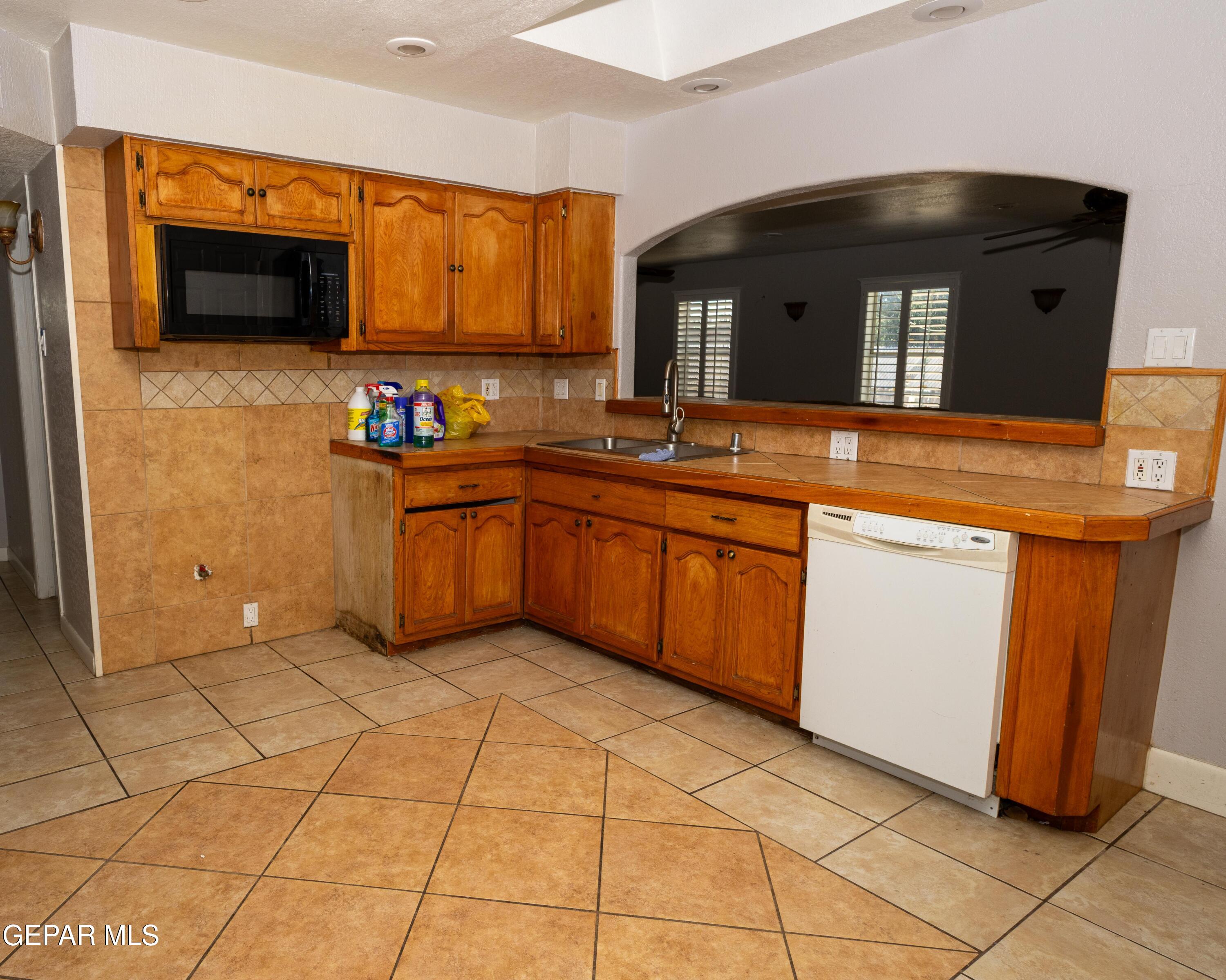 7860 Porche Street El Paso, TX 79915 - Photo 2 of 10 a kitchen with stainless steel appliances granite countertop a sink and a stove