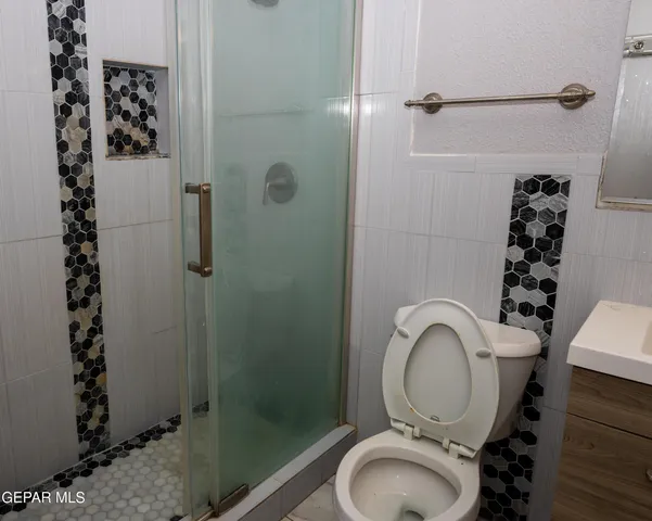 a bathroom with a toilet and a shower