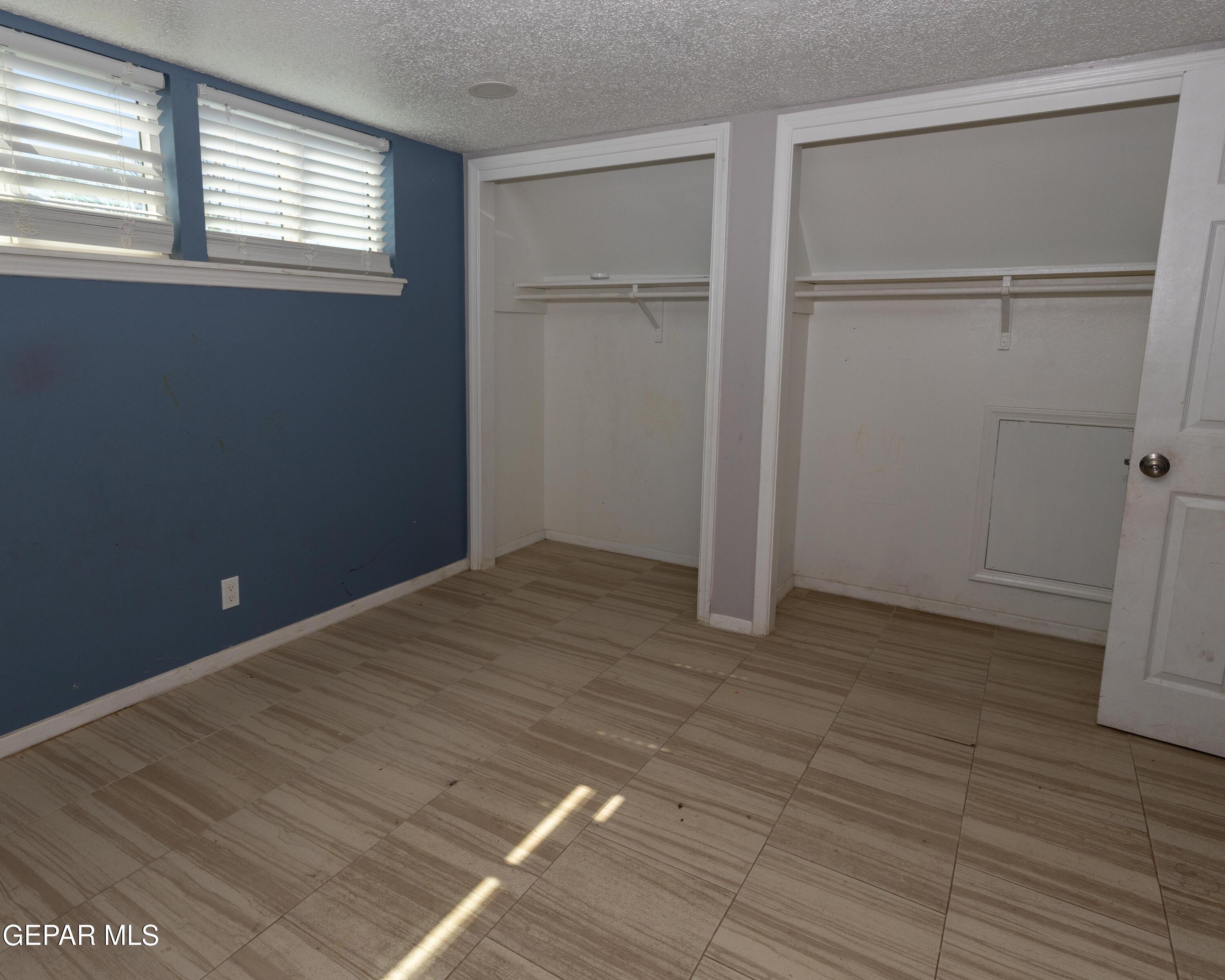 7860 Porche Street El Paso, TX 79915 - Photo 8 of 10 an empty room with wooden floor closet and windows